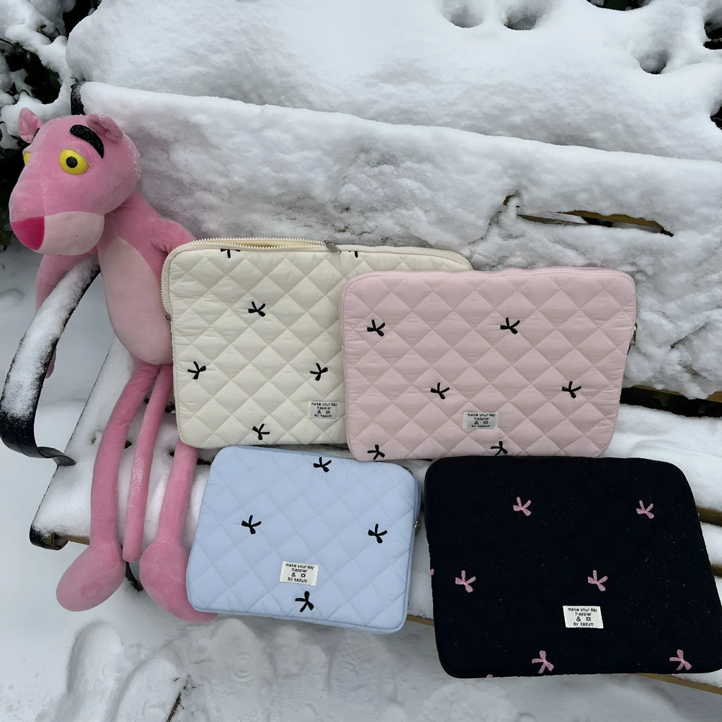 Cute rhombus embroidered bow laptop storage bag in nylon, shown in light pink colour.