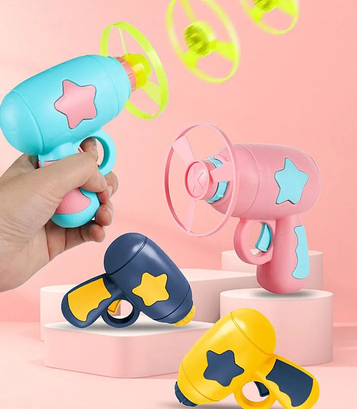 Flying saucer launcher toy set with plastic disc shooter gun, flashing discs, and target board, in blue, navy, pink, and yellow