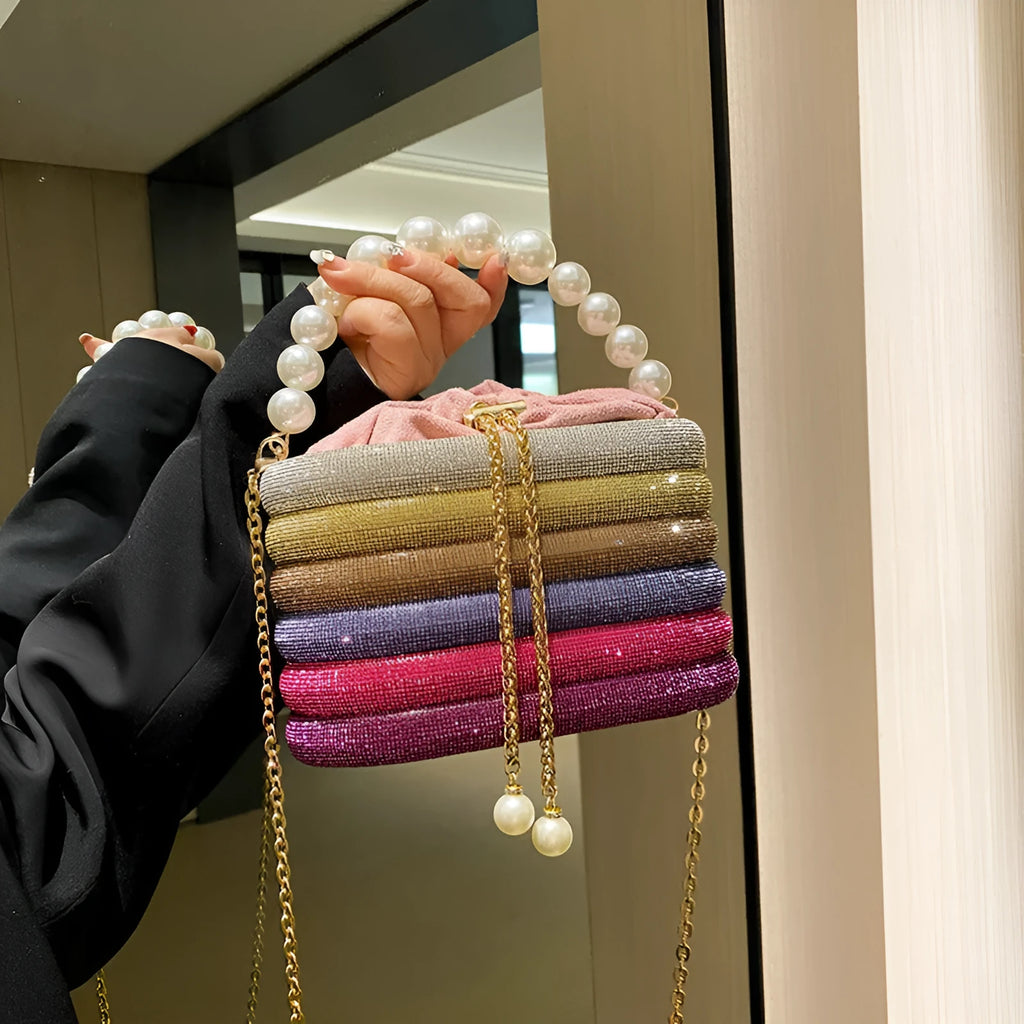 Round women's crossbody bag with beaded pearl details and single shoulder strap in retro styling
