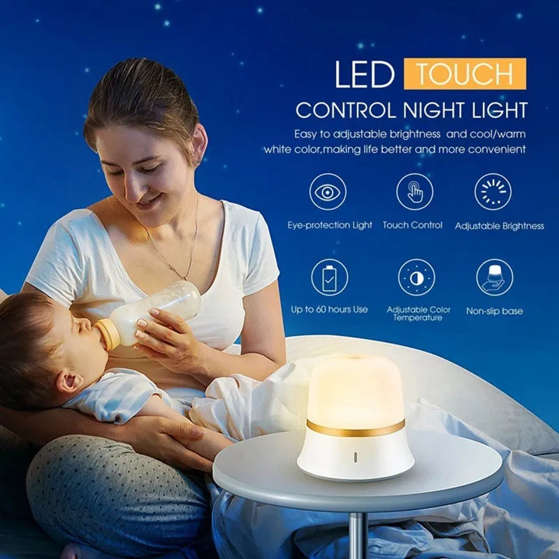 White rechargeable bedside night light with touch controls on a wooden table.