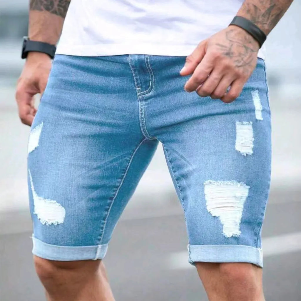 Sky blue men's denim shorts with multi-hole distressed design and low waist straight cut