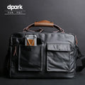 Dpark black men's shoulder bag for 14 or 15 inch laptops on a table