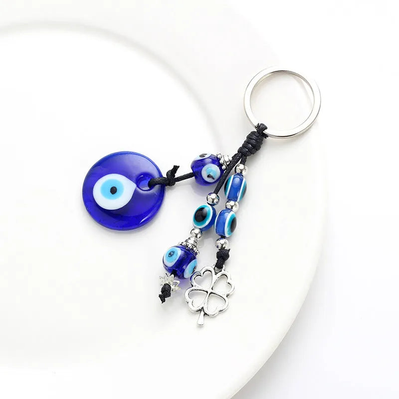 Blue evil eye keychain with metal plant-shaped pendant and unisex keyring design