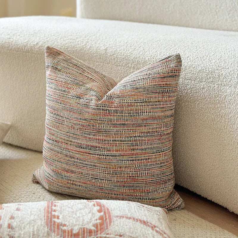 American-style yarn-dyed jacquard pillow cover with paisley pattern in amber colours on sofa