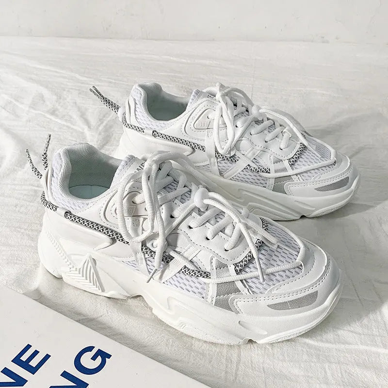Men's white platform dad shoes with lace-up front on a neutral background.
