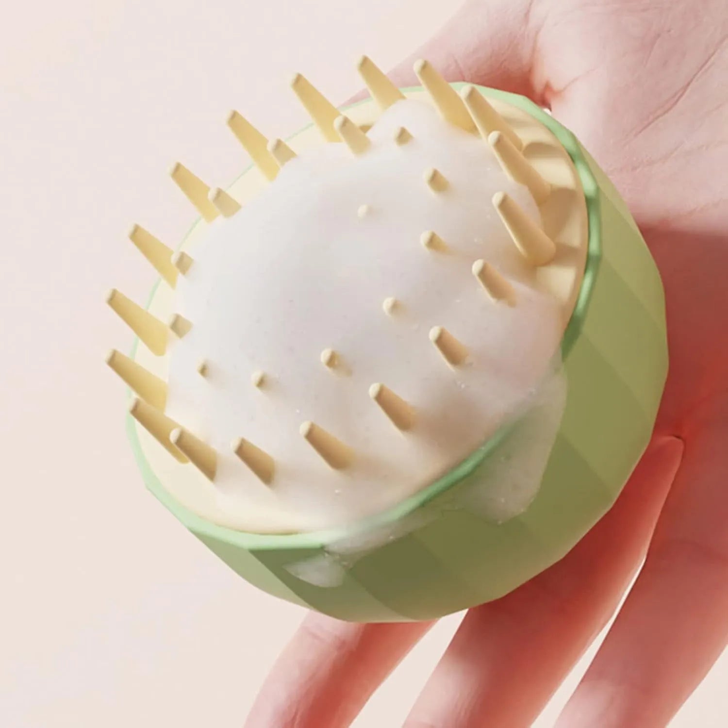 Green pet bath brush with soft bristles and drainage holes for dog and cat grooming