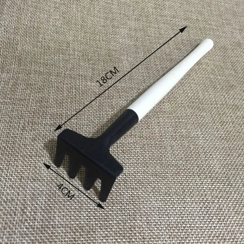 14-piece succulent gardening tool set showing watering can, tweezers, mini shovels, rake, and scissors on a table.