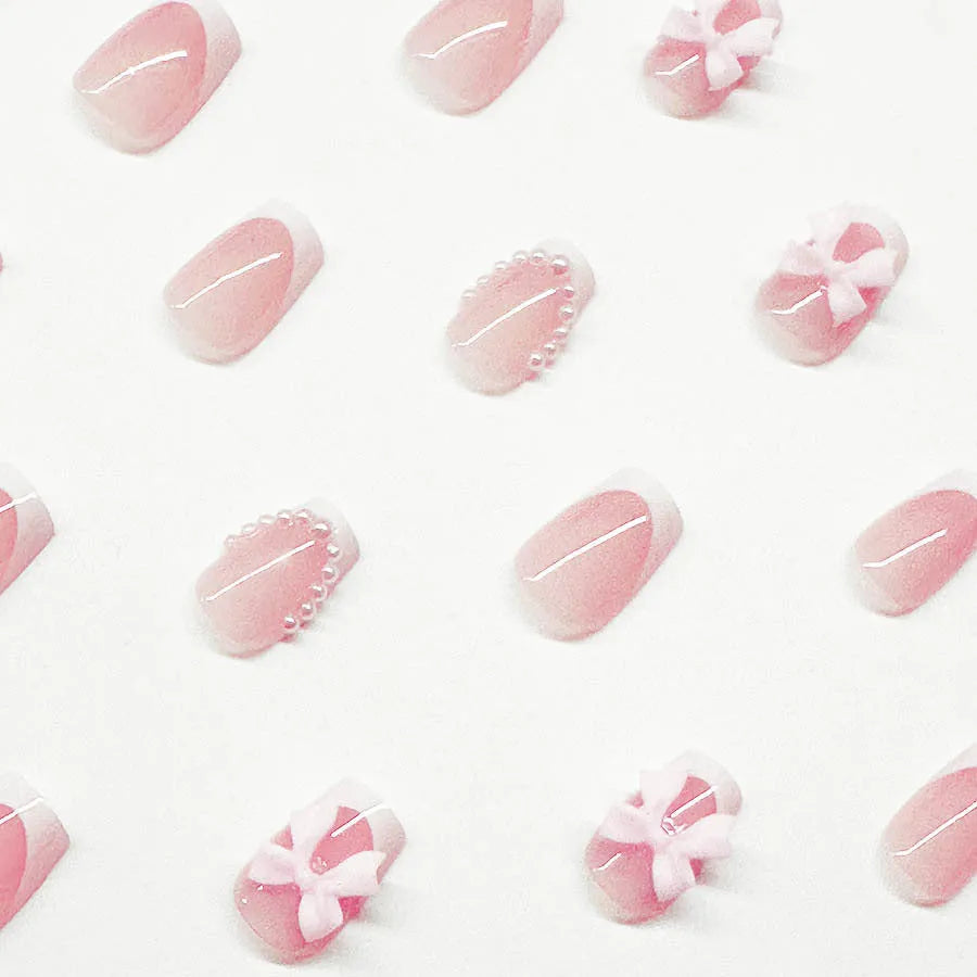 Short white French false nails with cute bow and tulip patterns in sweet style for ladies