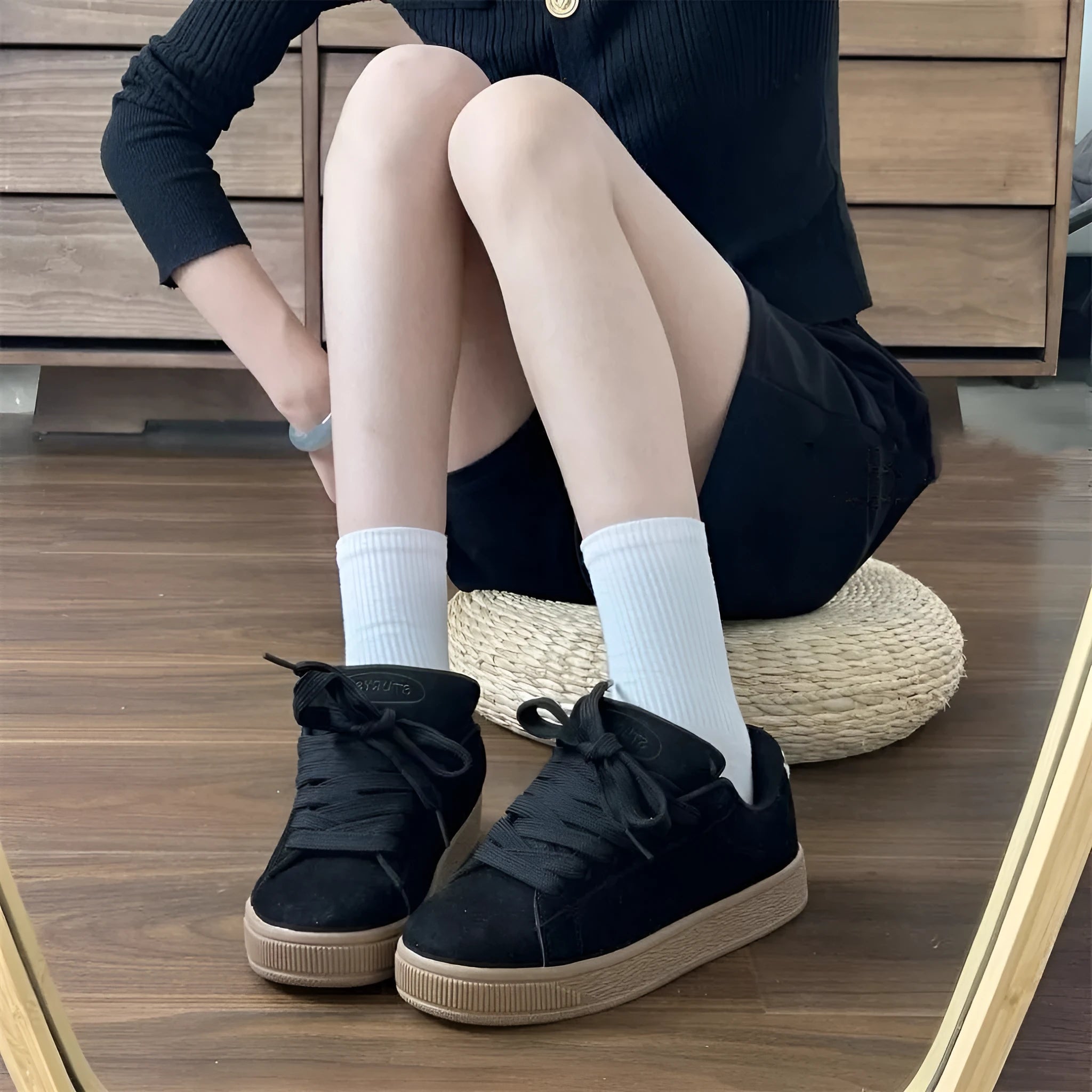 Black retro sneakers with round toe, lace-up front, and waterproof platform on rubber sole