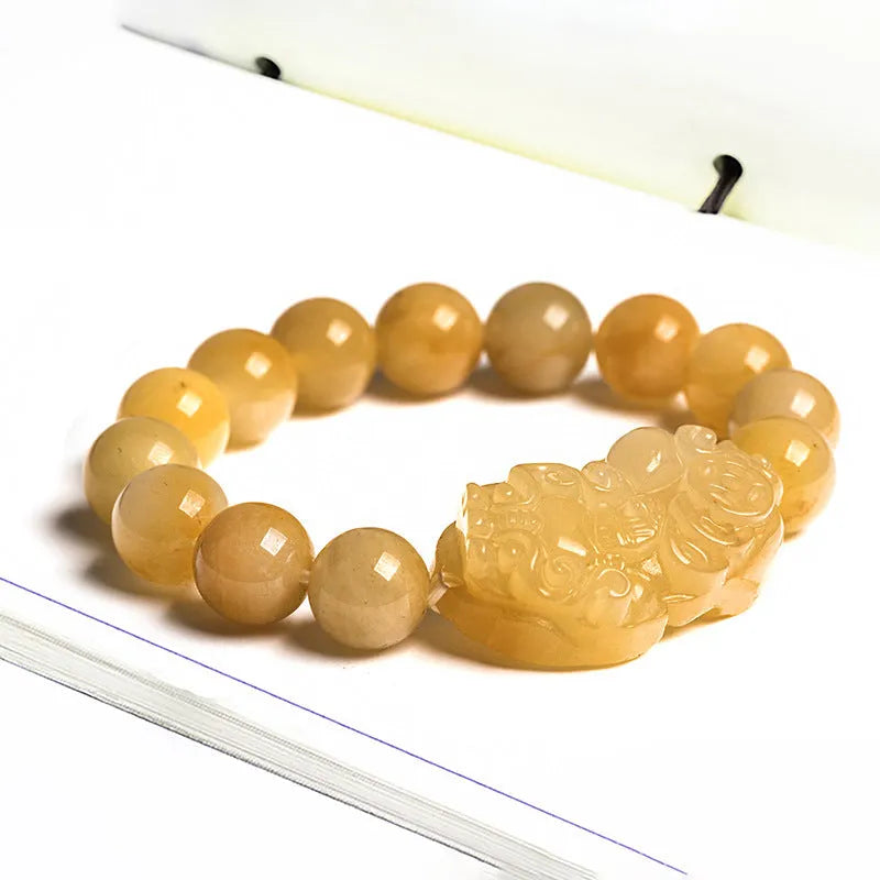 Personalised money symbol bracelet carved from golden thread jade, showing large and small size options.