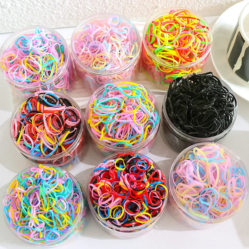 Pack of multicolour TPU baby hair ties in a reusable plastic storage container.