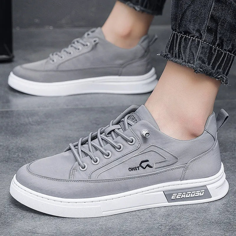 Grey men's canvas lace-up sneakers with round toe and low-top design on a rubber sole.