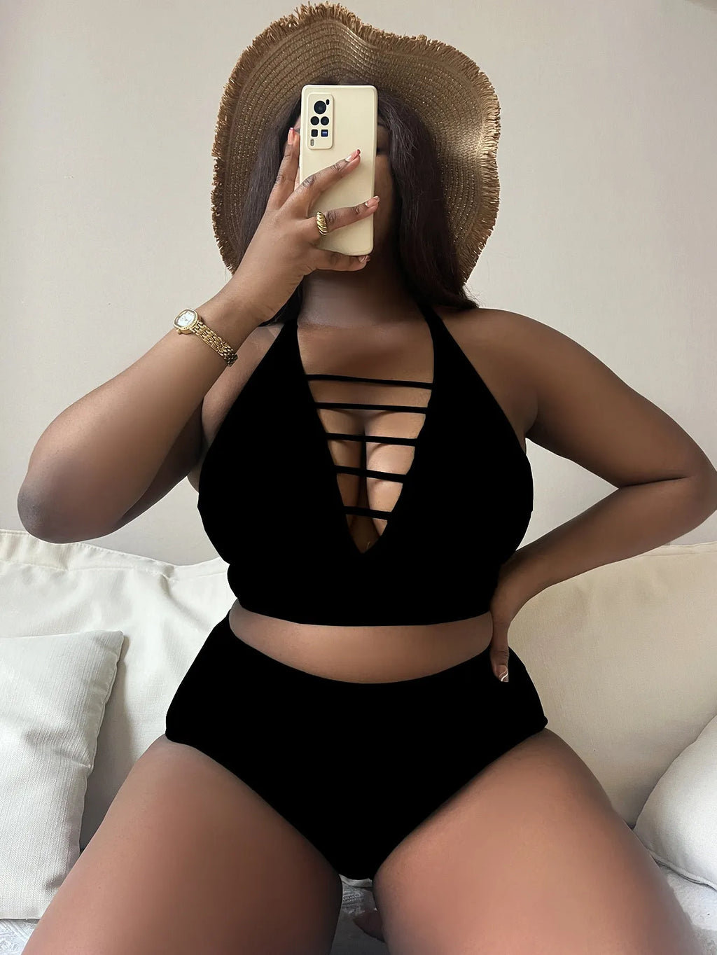 Plus-size woman in a black halter bikini with adjustable cross straps and high-waist briefs.