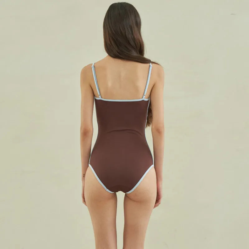 Brown women's one-piece swimsuit with a triangle top on a mannequin