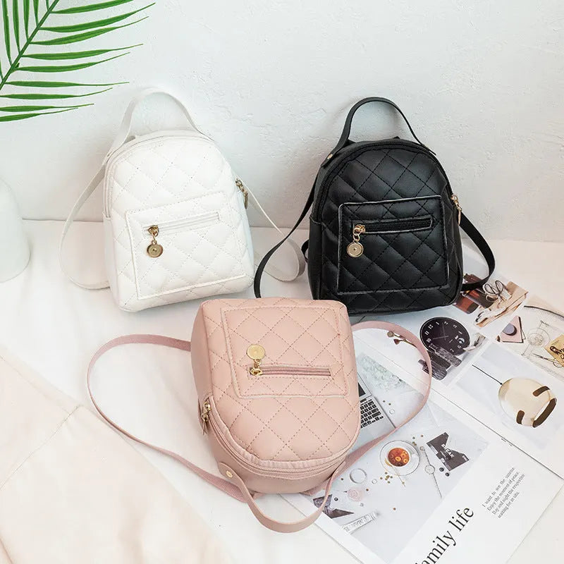 Girls square hard PU backpack with embroidery detail in black, pink or white, showing soft handle and outer pocket.