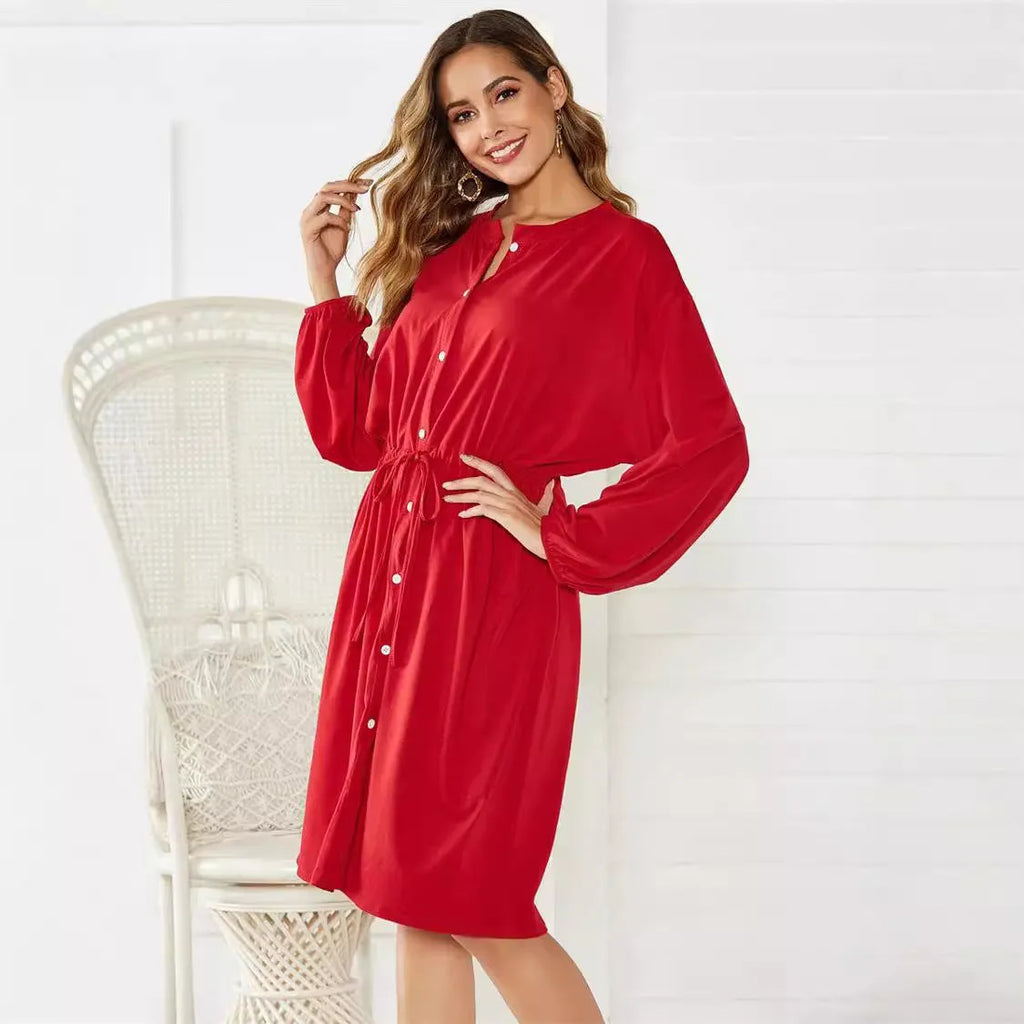 Black or red woven polyester dress with elastic waist, long sleeves, elastic cuffs, and a belt.