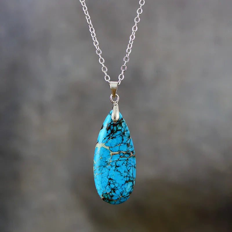 Emperor stone jade water drop pendant necklace with 18K gold plated chain on display.