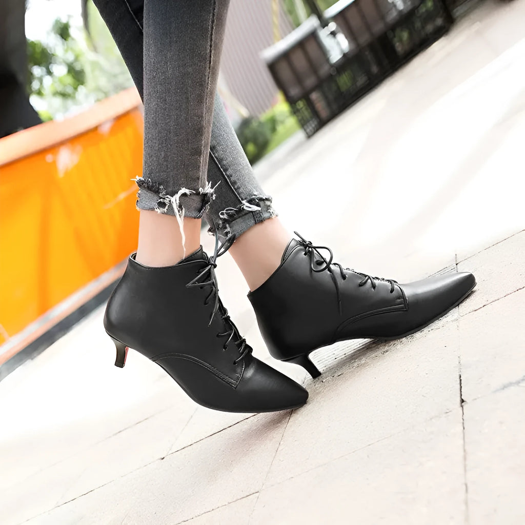Women's lace up short boots in black with mid heel and composite PU upper