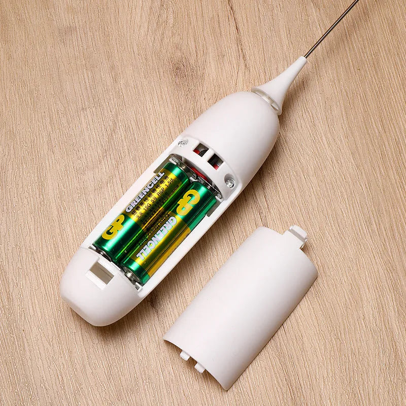 Black and white handheld electric milk frother with modern design for coffee preparation