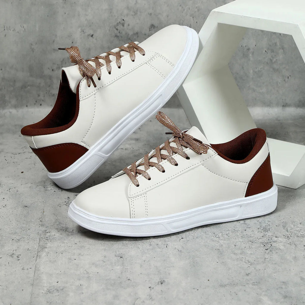 Beige brown platform casual skateboard sneaker with round toe and cross-strap detail on a white background.