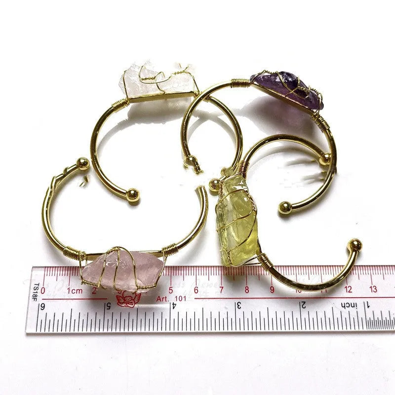 Geometric gold wire bracelet with unshaped natural rough stone crystals in bohemian style.