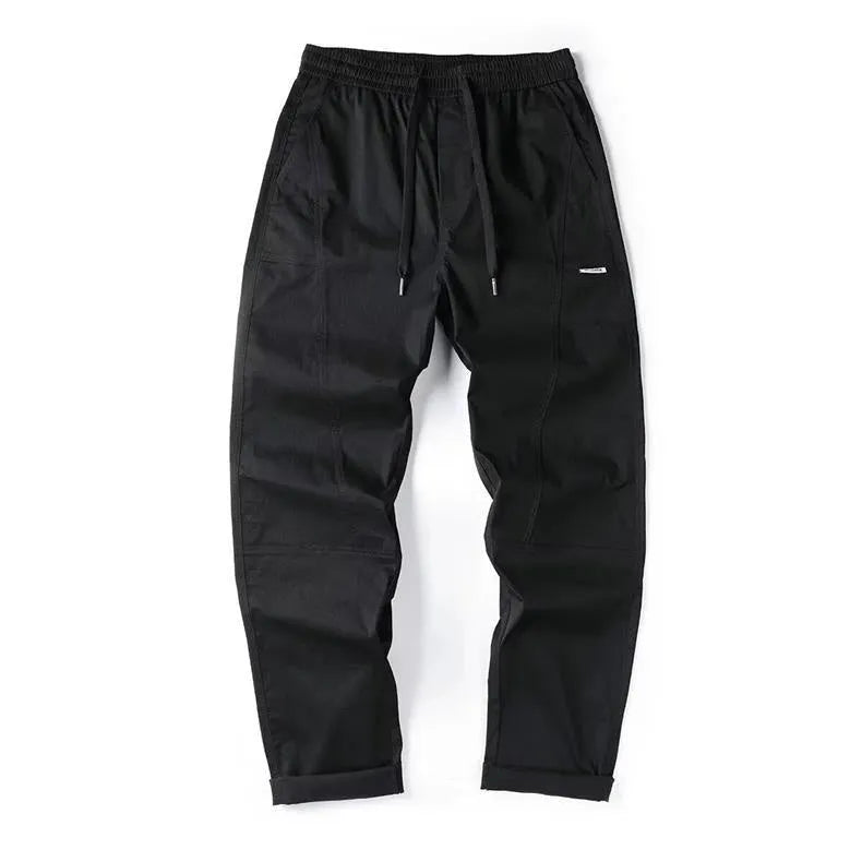 Milky white cotton wide-leg casual trousers with an elasticated waistband laid flat.