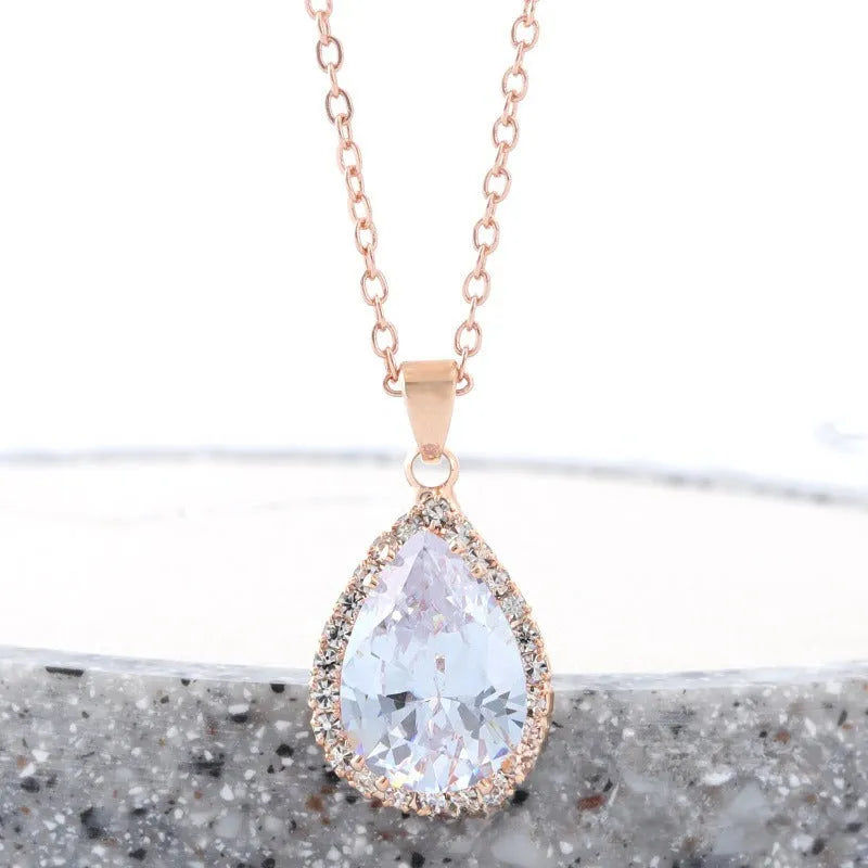 Drop-shaped pendant necklace with rhinestone and gemstone inlay in pink colour option