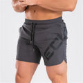 Men's black elastic quick-dry running shorts with mid waist and knee-length leg.