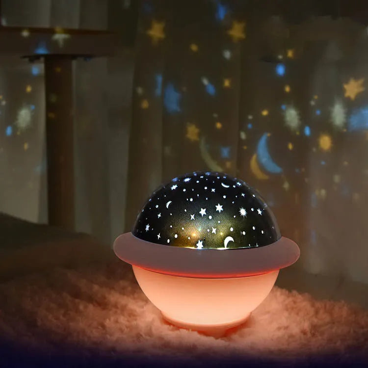 UFO-shaped star projection night light with rotating star patterns in green, pink or white colours