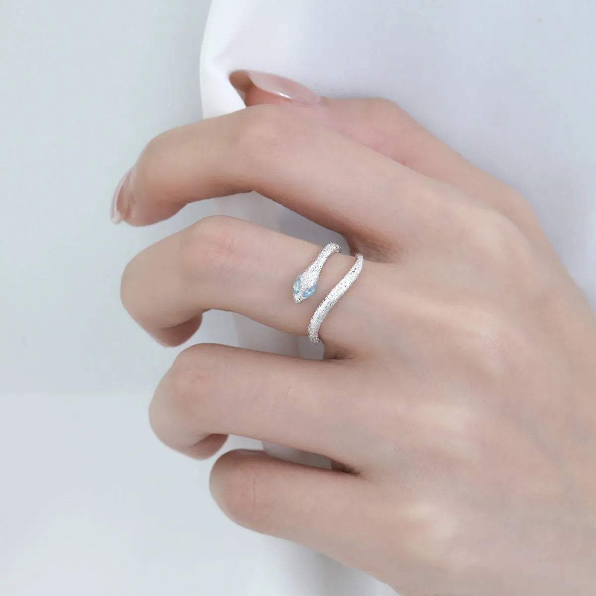 Silver adjustable snake ring with electroplated platinum finish and detailed zodiac design