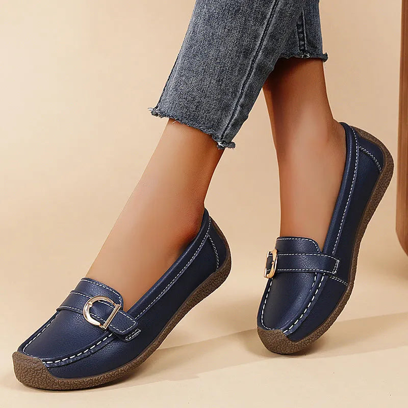 Women's beige casual flat loafers with round toe and slip-on design on a soft sole.