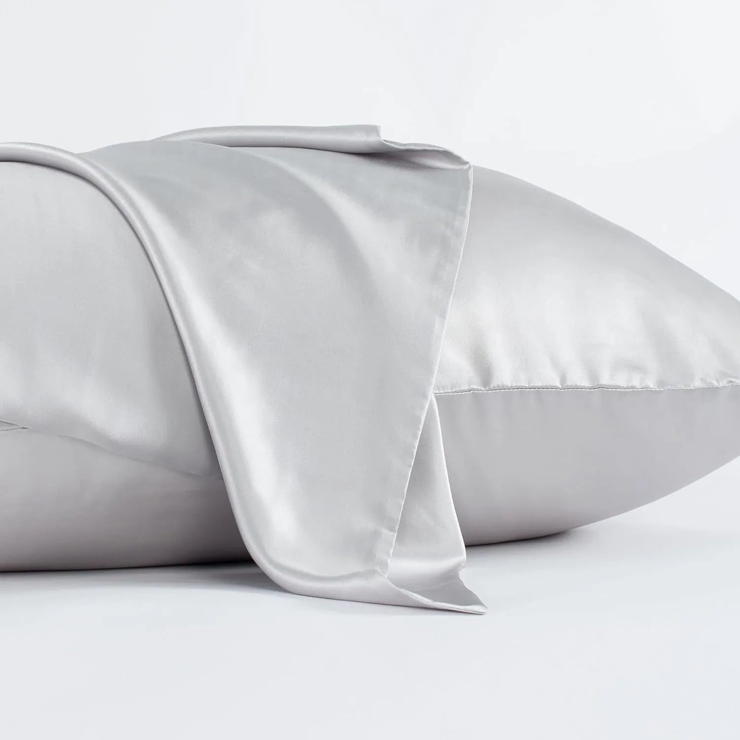Dark grey 19 momme mulberry silk pillowcase showing envelope closure on a bed.