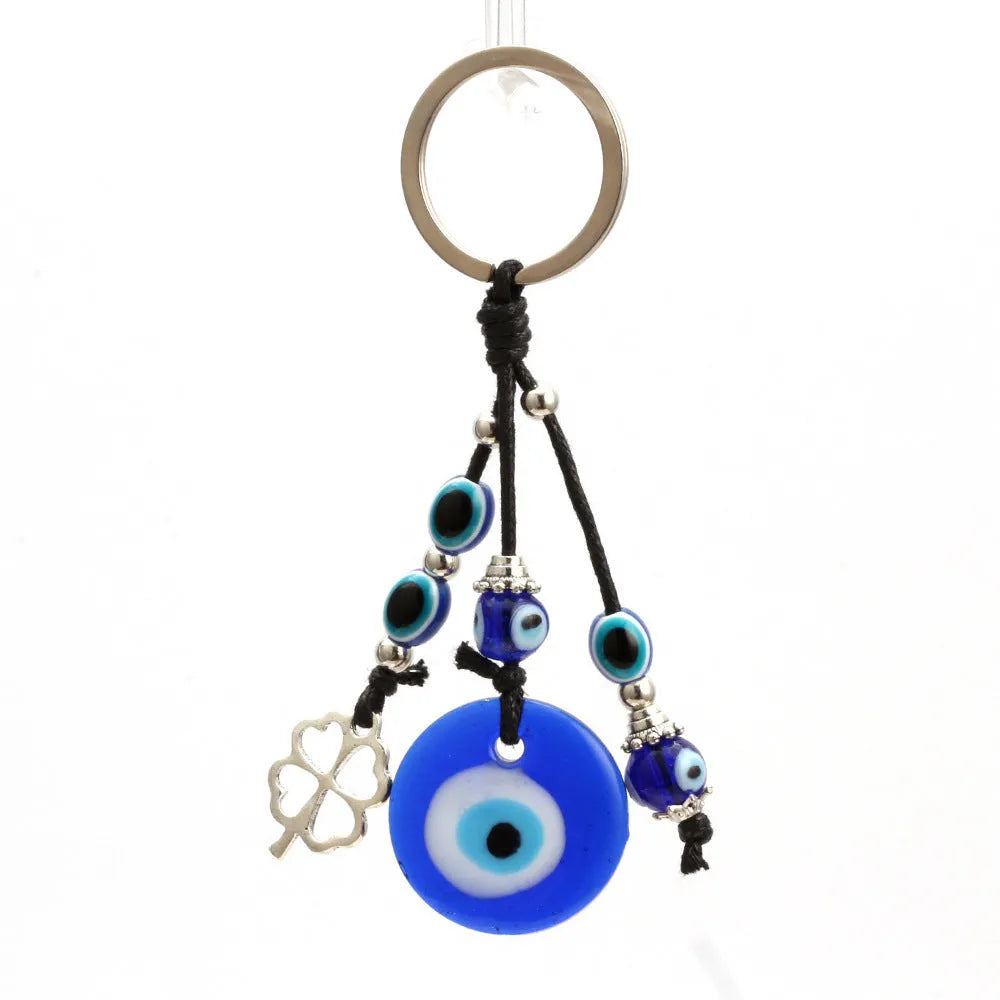 Blue evil eye keychain with metal plant-shaped pendant and unisex keyring design