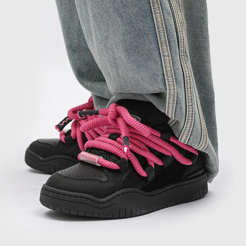 A pair of low-top casual sneakers with a thick rubber sole and front lace-up closure, shown in a choice of four colours.