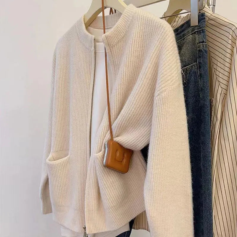 Beige soft viscose women's sweater coat cardigan with long sleeves on a hanger.