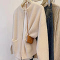 Beige soft viscose women's sweater coat cardigan with long sleeves on a hanger.