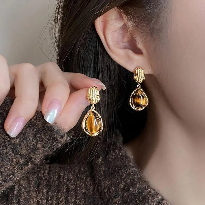 Three pairs of handmade holiday ear rings in geometric designs with tassel elements