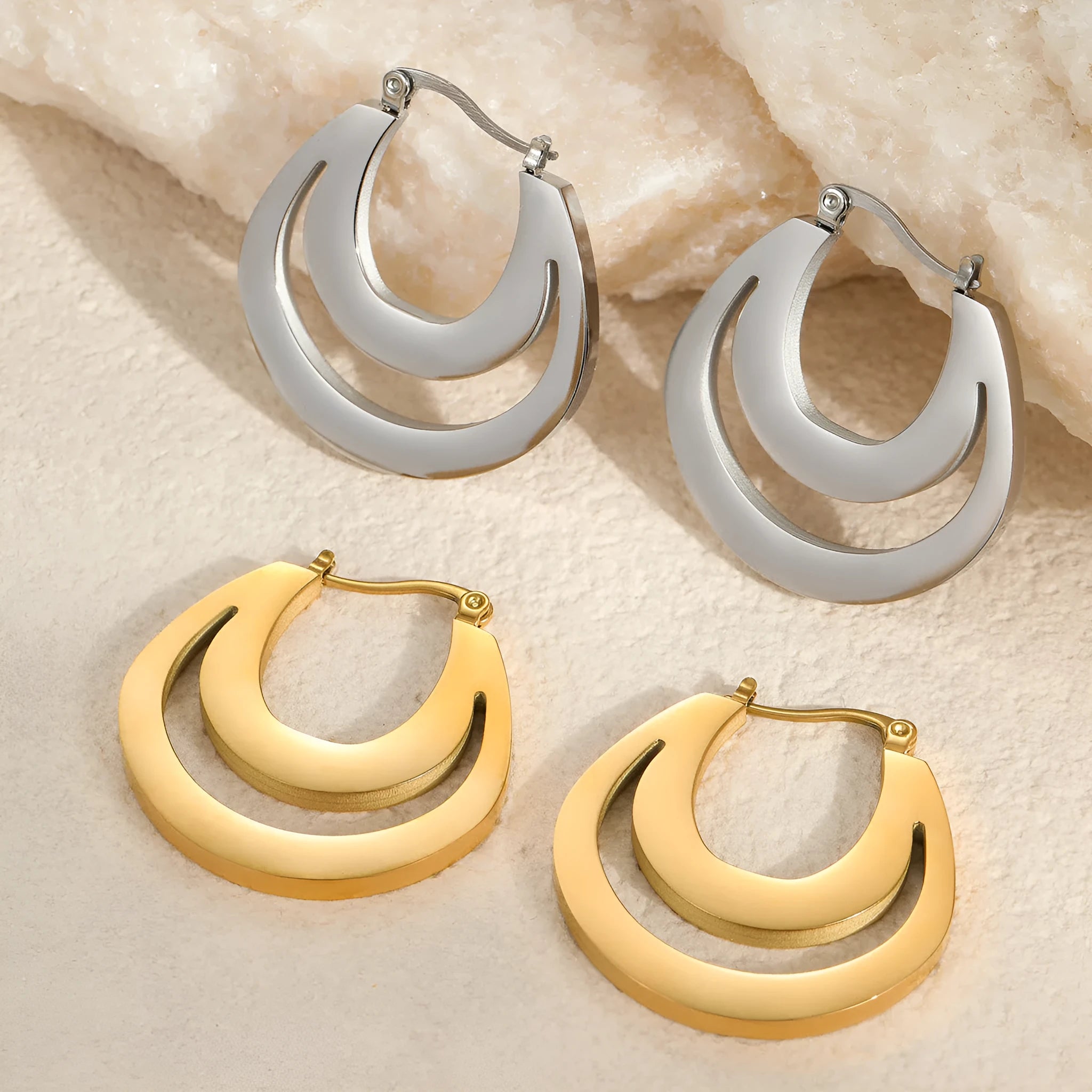 Geometric metallic French earrings with round ring elements in gold and steel finishes