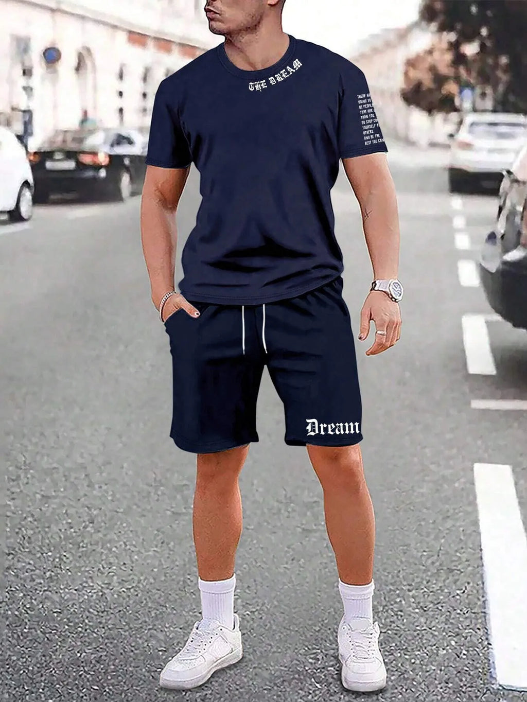Man wearing a grey short sleeve athletic top and matching shorts from a polyester sportswear set.