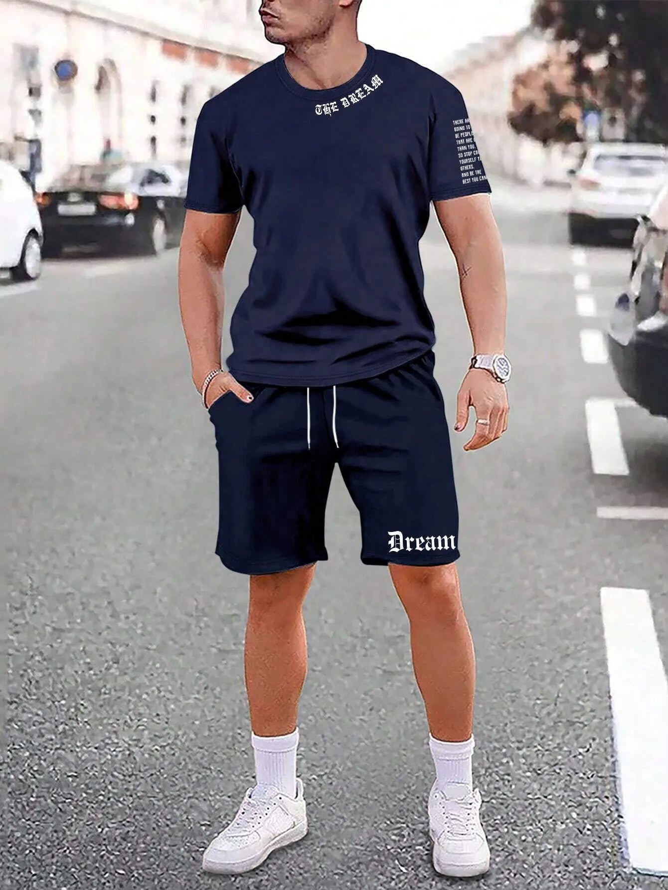 Man wearing a grey short sleeve athletic top and matching shorts from a polyester sportswear set.