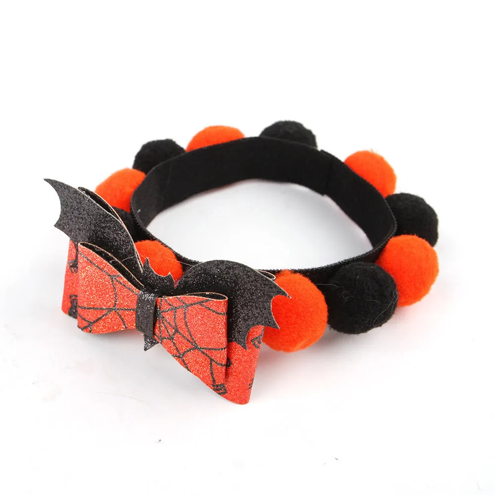 Halloween pet fur ball collar with pumpkin decoration in orange and black festive designs.