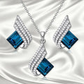 Women's alloy and glass necklace with matching ear studs featuring cross chain design