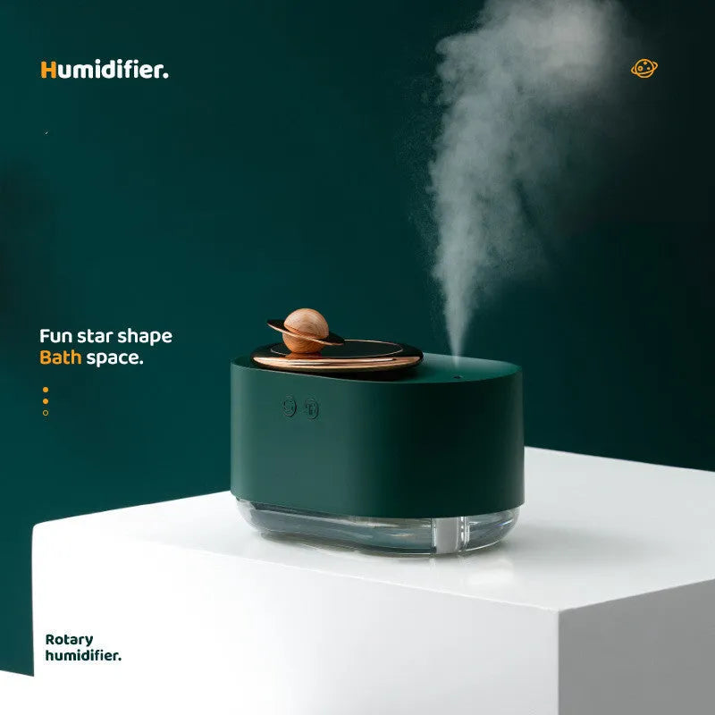 Green rotating planet-shaped USB humidifier with night light on a table