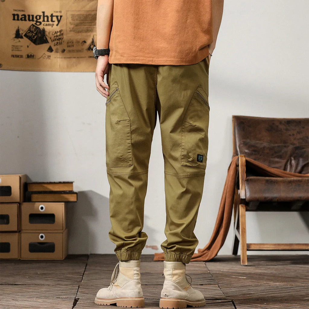 Men's loose-fit cotton harem pants in a solid colour with ankle bands and a mid waist.