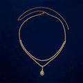 Gold coloured waist chain with a sparkling rhinestone water drop pendant and tassel details.