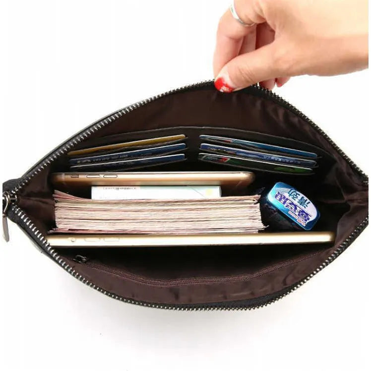Men's PU leather clutch bag in black with wrist strap, soft carry handle, and zipper compartments