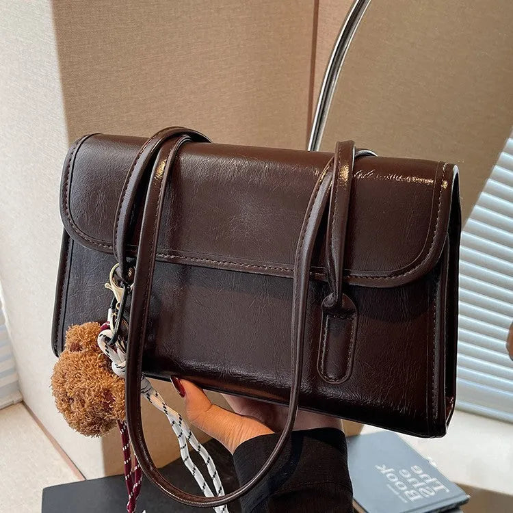 Women's brown PU Maillard shoulder bag with pendant showing horizontal square shape and dual straps