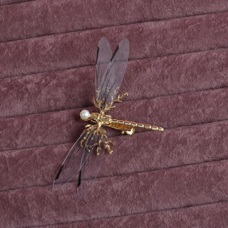 Golden dragonfly-shaped women's hair clip made from alloy with a side fastening.