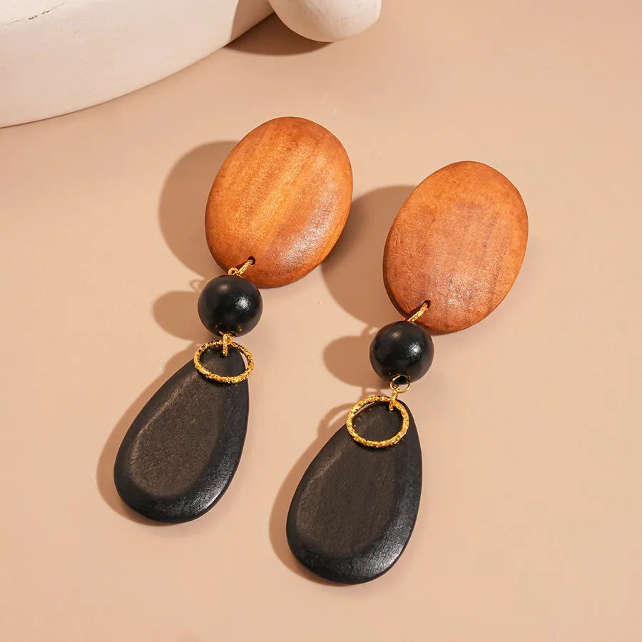 Retro wooden ellipse earrings handmade in brown-black colour with silver needle detailing
