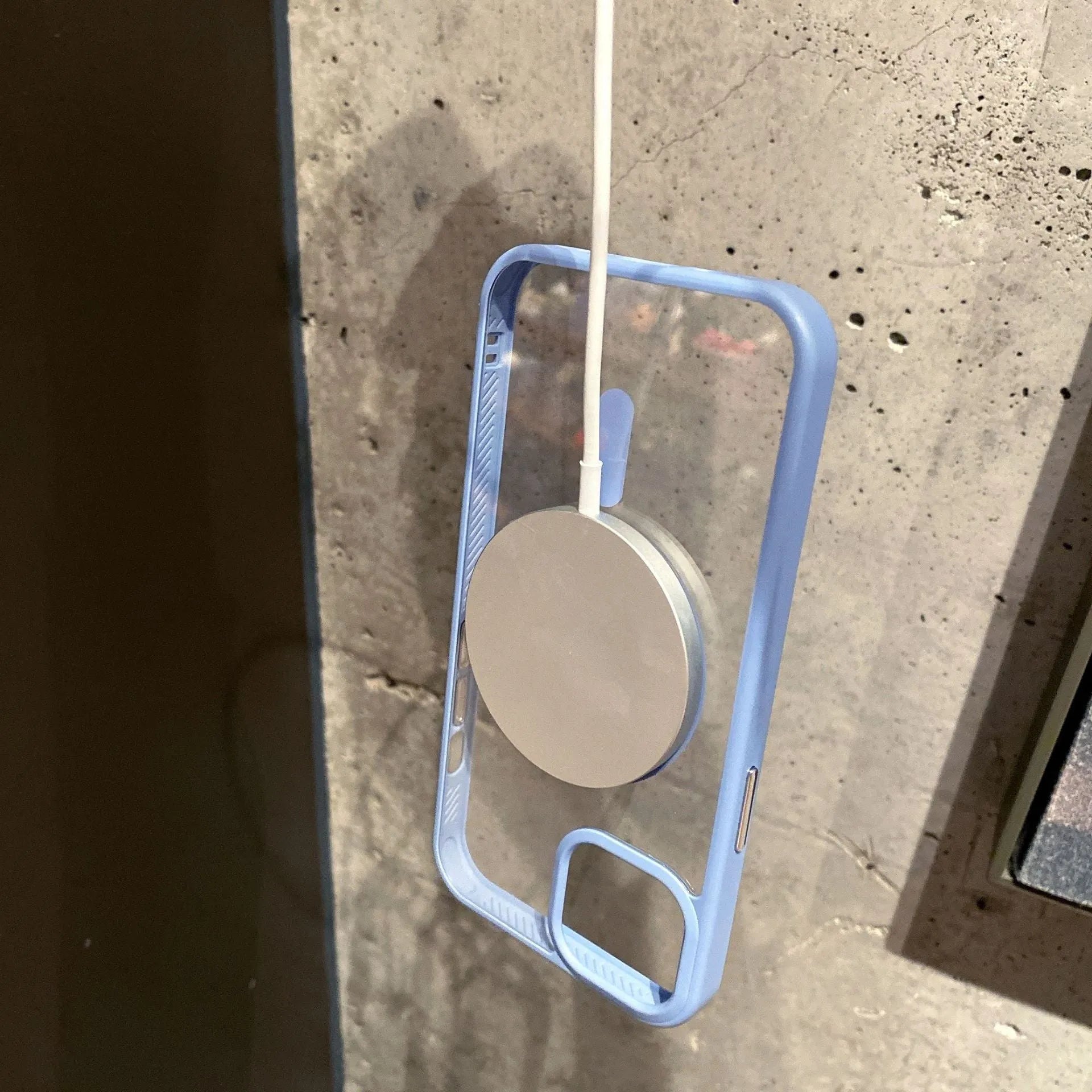 Transparent magnetic iPhone case showing phone through clear acrylic back with MagSafe compatibility